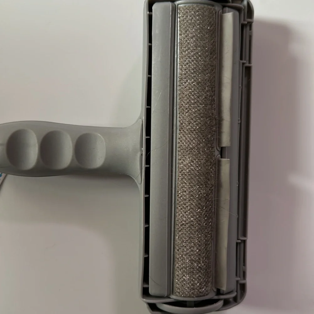 NWT pet hair remover roll the brush along any surface with pet hair and voila